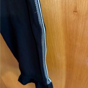 Betsey Johnson Black Ankle Pants with Silver and White trim with ruffle.